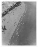Aerial view of oceanfront hotels, green spaces, and buildings looking north