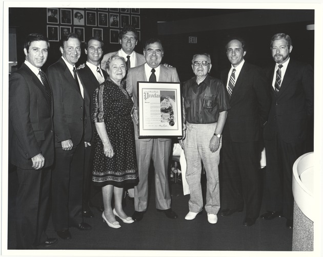 City Manager Rob Parkins and Commissioners at different events, 1984-1987 - Photograph, recto: [Left to right, Malcolm Fromberg, Sy Eisenberg, Bruce Singer, unidentified woman, Alex Daoud, City Clerk Dr. Malek, unidentified man, and City Manager Rob Parkins]