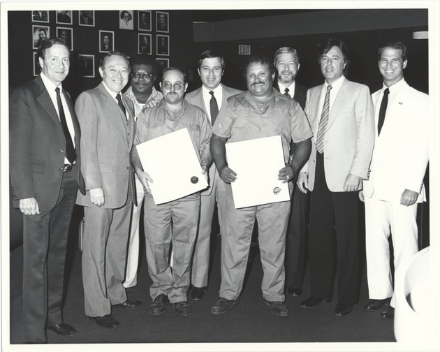 City officials at various events, 1985 - Photograph, recto: [View of City officials presenting Fire Rescue officers with certificates of appreciation]