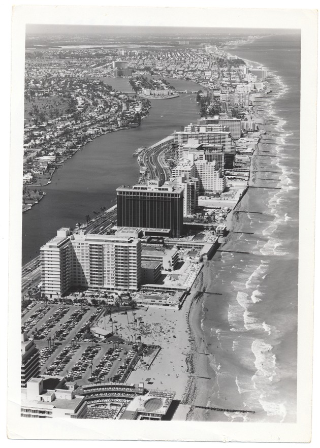 Aerial views of oceanfront hotels - Photograph, recto: [View of ocean front hotels. The Doral Hotel in the center and Alison Island in the back]