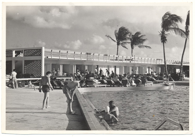 Hotel pool and hotel guests swimming