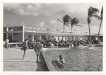 Hotel pool and hotel guests swimming