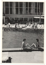 Hotel pool and hotel guests sunbathing