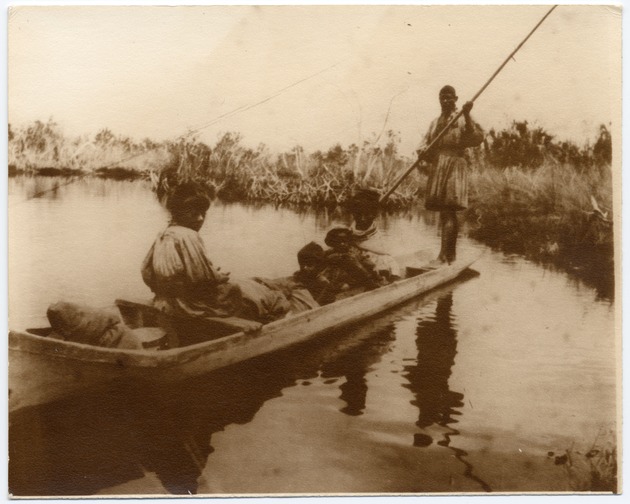 A  Seminole Indian family canoeing in the Everglades - Front