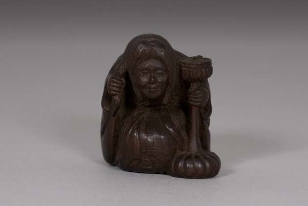 Netsuke: Old Woman Holding Candlestick - artifact front view