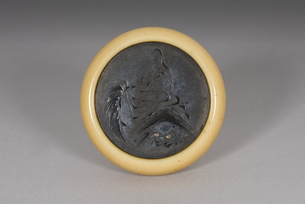 Kagamibuta netsuke: Monju Bosatsu riding Shishi