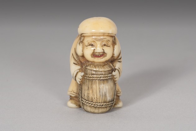 Netsuke: Daikoku holding a rice bale - artifact front view