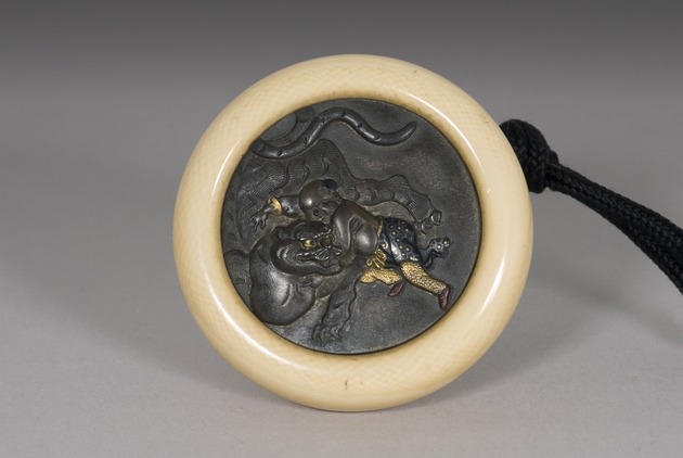 Kagamibuta netsuke: Benkei fighting a tiger
