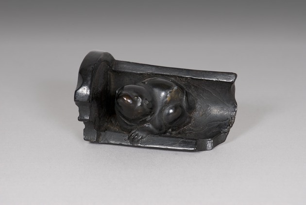 Netsuke: puppy seated on roof tile - artifact front view