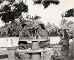 Couple talking at a table at the Venetian Pool. Coral Gables, Florida