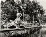 Woman walking down the catwalk at the Venetian Pool. Coral Gables, Florida