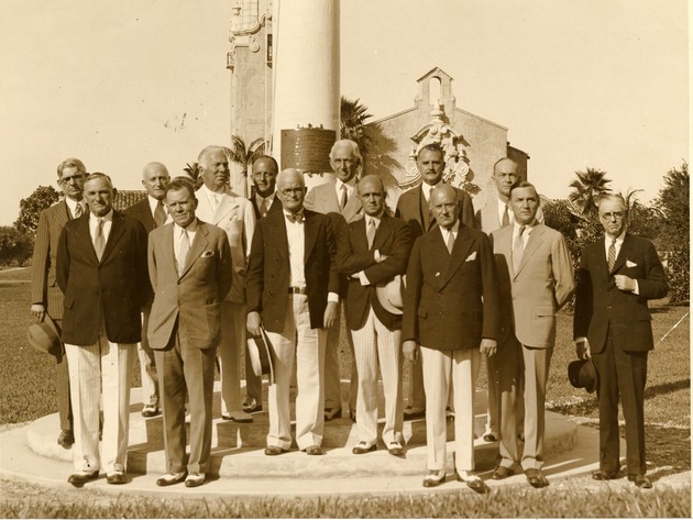 Group portrait next to the flagpole in memory of John McEntee Bowman. Coral Gables, Florida - Recto