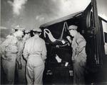 Military officials looking at a patient inside an ambulance. Pratt General Hospital former Biltmore Hotel. Coral Gables, Florida