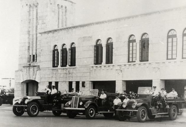 Firefighters posing on their fire trucks at Old Police and Fire Station Building. Coral Gables, Florida - Recto