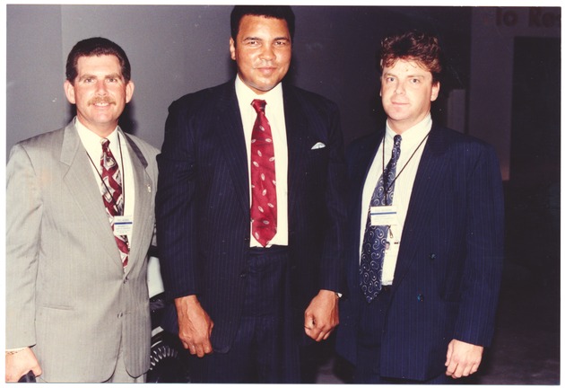 Muhammad Ali's visit to Miami Beach, 1990s - Photograph, recto: [View of Muhammad Ali with two men]