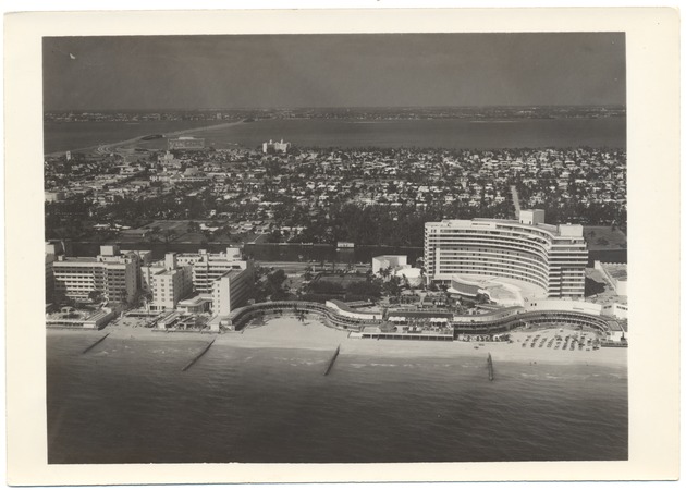 Aerial views of Miami Beach, 1950s - Photograph, recto: [Aerial view of Miami Beach from the ocean. View of the Fontainebleau Hotel and the Julia Tuttle Causeway]