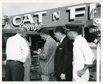 [1959] Journalists interviewing firefighter on incident at Cat'n Fiddle restaurant and lounge