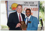 Marlins General Manager, Larry Beinfest, receives an award from Andre Pierre on behalf of the North Miami Chamber of Commerce
