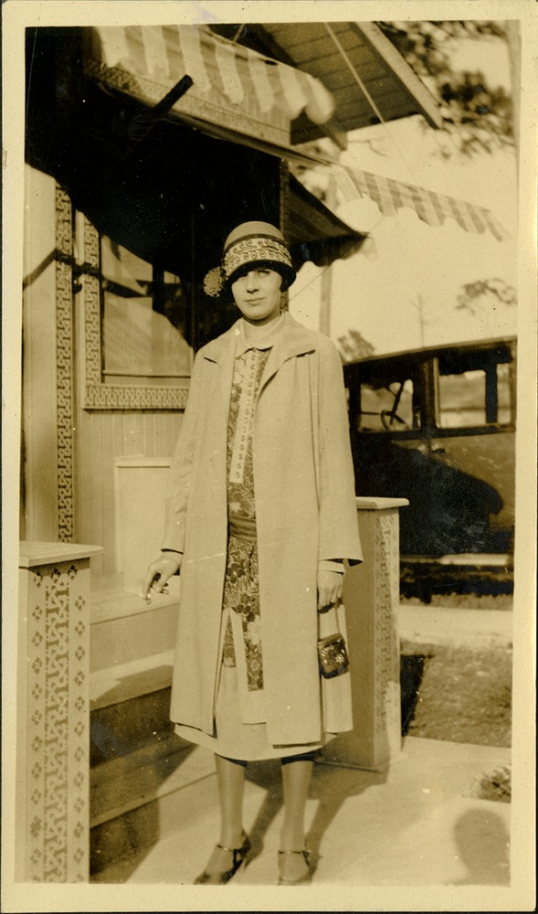 Woman outside house with cigarette