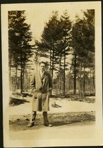 G.L.C - Man in suit in front of trees