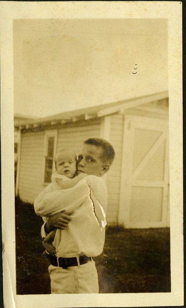 Young boy holding baby