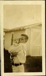 Young boy holding baby