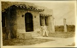 Young man and dog outside of house