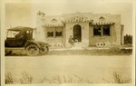 Woman, dog and car outside of house