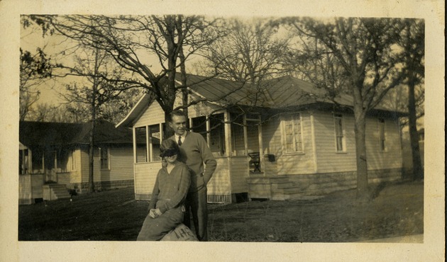 Jack Badger - Man and woman posing in front of house