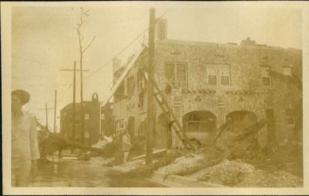 El Lorene Apts - Women in flooded street near damaged building