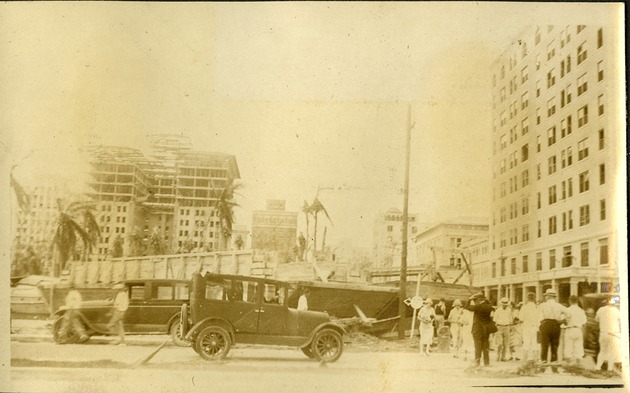 Corner - Flagler and Bayshore Drive - People in street, cars, buildings in background, one under construction