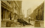 NE 1st Street looking East - Man standing next to damaged car and hurricane debris