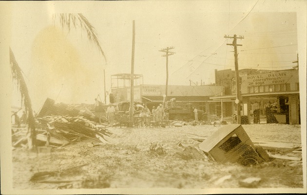 South Beach - note the car - Street near "Royal Palms" Car sunk in ground, hurricane debris