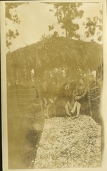 Group of three women and one man sitting in gazebo