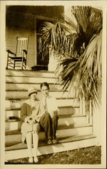 B and E - Man and woman sitting on steps facing camera