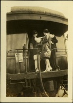 Two women and a man at back of train car