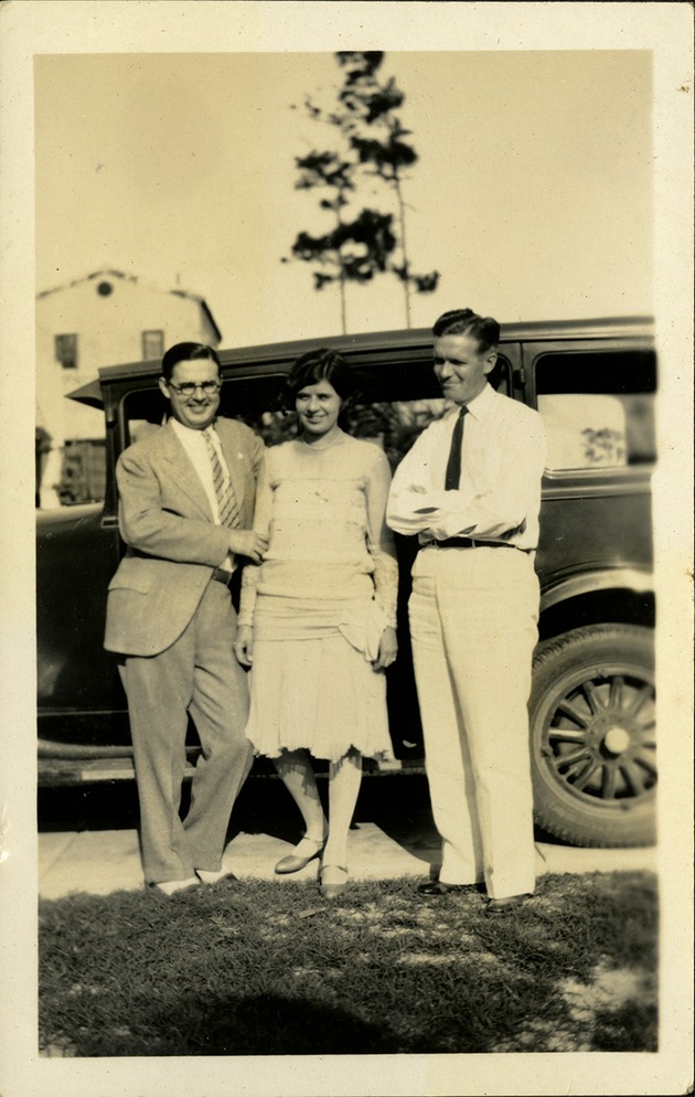 Walter Ashton Drummond with a woman and a man standing in front of car