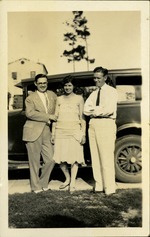Walter Ashton Drummond with a woman and a man standing in front of car