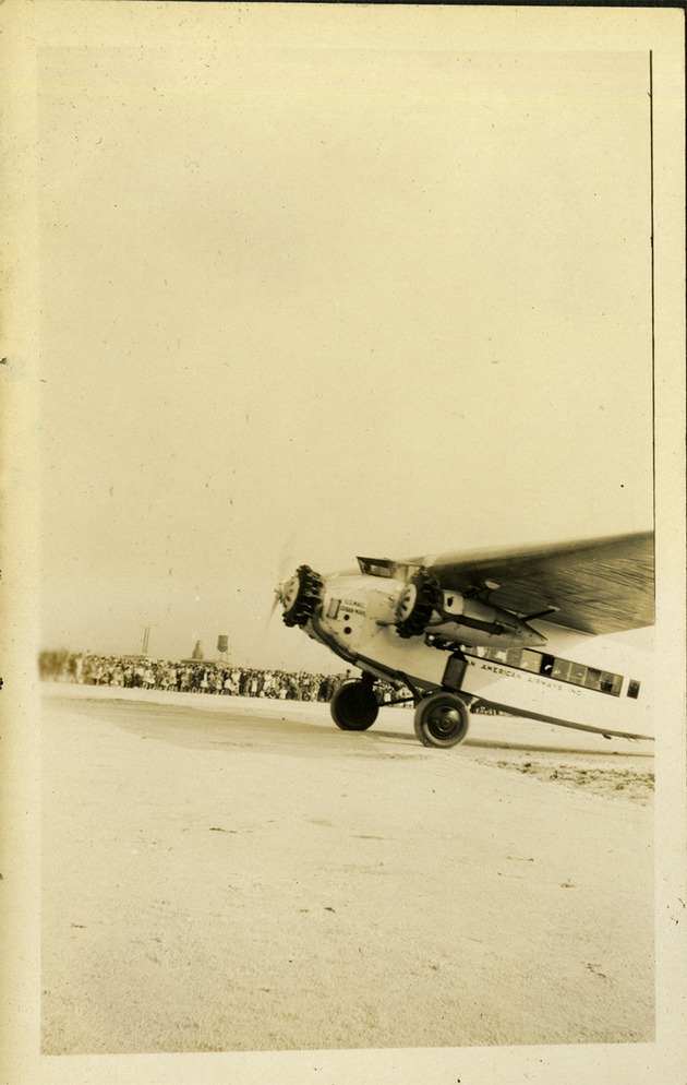 Plane on ground, people in far background