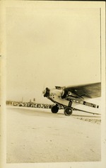 Plane on ground, people in far background