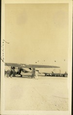 Charles Lindbergh - back of airplane with people beside it and crowd in the background
