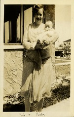 Sis [FitzGibbon Drummond, Eva] + Billy - Eva holding baby Billy smiling at camera outside home