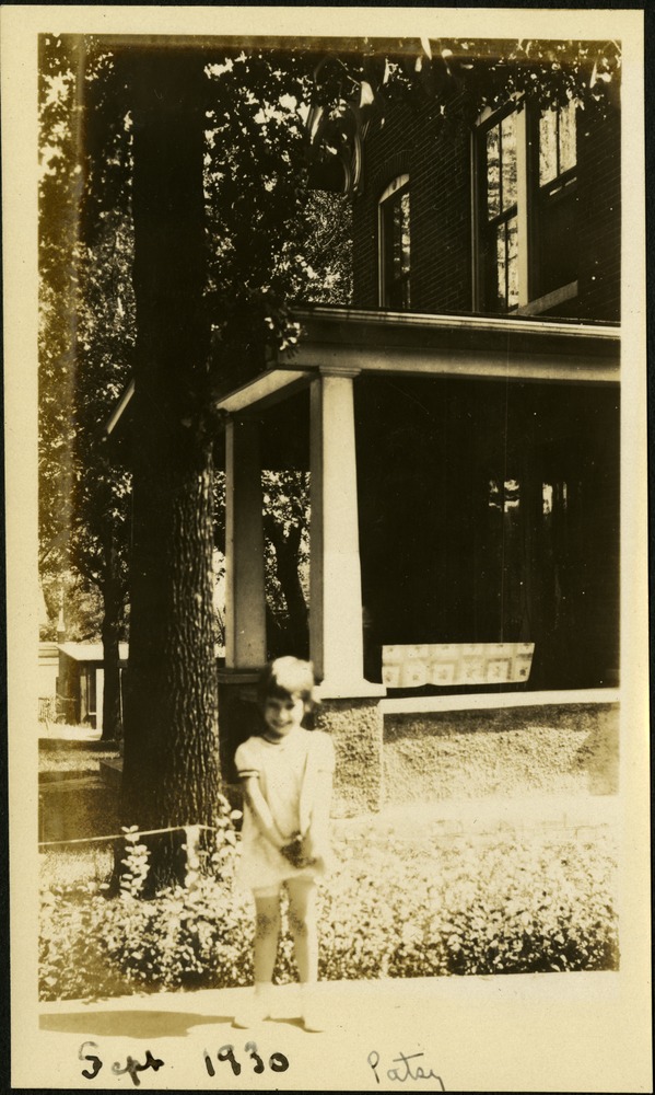 Patsy - Small child standing outside of house near tree