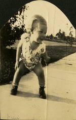 Drew [Drew Healy] - Small baby bent over on sidewalk, smiling