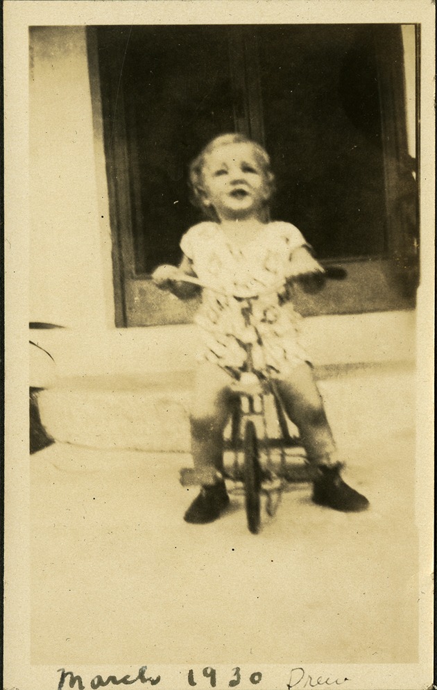 March 30 - Drew [Drew Healy]- Small child on bike in front of house steps