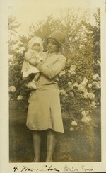 4 months baby Lou - Woman holding baby in front of flowers