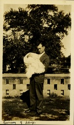 Tommy 8 days  - Man holding baby outside