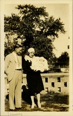Tommy - Woman holding baby Tommy, man next to her smiling down at child