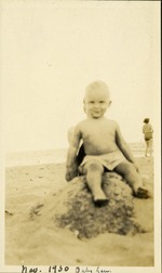 Nov. 1930 - Baby Lou - Baby sitting on rock in sand at the beach
