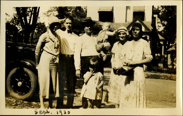 Sept 1930 - Men and women and two children outside home near car